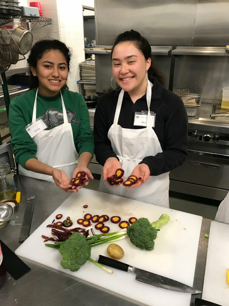 high school students working with vegetables